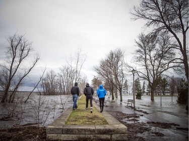 People walk along a limited amount of path in Britannia Park Saturday, April 27, 2019.