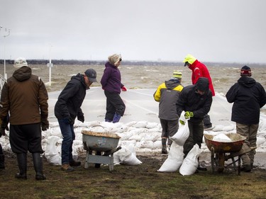People were building a wall of sandbags and plastic to try to hold back the Ottawa River near the Britannia Yacht Club Saturday, April 27, 2019.   Ashley Fraser/Postmedia
