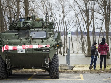 A Canadian Forces armoured vehicle sits near Parc des Cèdres as the Ottawa River shows high levels of flooding Saturday, April 27, 2019, in Aylmer.   Ashley Fraser/Postmedia