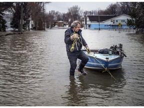 Richard Lafrance pulls his boat up to higher ground on Rue Saint-Louis, Saturday, April 27, 2019. Lafrance's home went through flooding in 2017. After renovations the home seems to be avoiding flooding so far, with a small amount of water in the basement at this point.