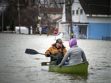 Marc-Andre Hebert and Anne-Marie Giroux paddled a canoe up Rue Saint-Louis Saturday, April 27, 2019.