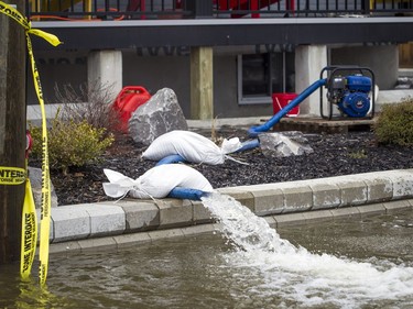 The Gatineau River rose above Rue Jacques-Cartier Saturday, April 27, 2019. Pumps were busy moving water out of homes on the street.   Ashley Fraser/Postmedia