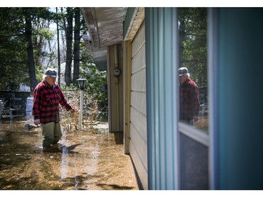 Wes Dodds asses the water levels hitting his flooded summer home. A state of emergency was declared in Rhoddy's Bay, west of Arnprior, on the Ottawa River Sunday, April 28, 2019.