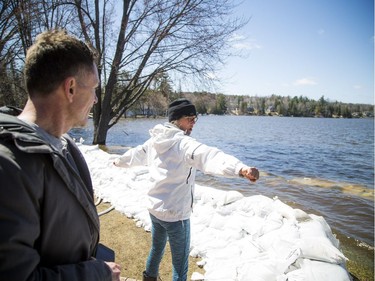 Kevin Dodds and Christine L'Abbe share stories on how they are trying to stop the water and salvage as much as they can. A state of emergency was declared in Rhoddy's Bay, west of Arnprior, on the Ottawa River Sunday, April 28, 2019.