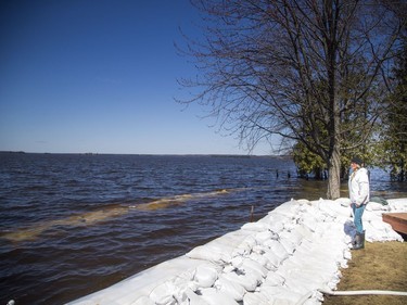 Christine L'Abbe looks out to the two sand walls built around her home, trying to stop the water from hitting her families home. A state of emergency was declared in Rhoddy's Bay, west of Arnprior, on the Ottawa River Sunday, April 28, 2019.