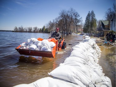 A tractor with a load of sandbags makes its way along the flooded Archibald Street. A state of emergency was declared in Rhoddy's Bay, west of Arnprior, on the Ottawa River Sunday, April 28, 2019.