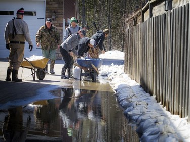 A state of emergency was declared in Rhoddy's Bay, west of Arnprior, on the Ottawa River Sunday, April 28, 2019. Crews continue to build endless walls of sandbags to try to hold the water out of their homes.