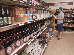 A customer shops in the craft beer section of the N.B. Liquor store in Fredericton. A 2017 Supreme Court of Canada ruling that provinces have the right, with limits, to enact laws that restrict interprovincial commerce, represents a "missed opportunity" according to many.