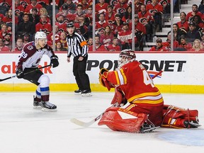 Nathan MacKinnon #29 of the Colorado Avalanche scores the game-winning goal against Mike Smith #41 of the Calgary Flames in Game Two of the Western Conference First Round during the 2019 NHL Stanley Cup Playoffs at Scotiabank Saddledome on April 13, 2019 in Calgary, Alberta, Canada.