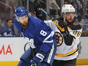 The Leafs' Jake Muzzin keeps an eye on the Bruins' David Pastrnak during Game 3.