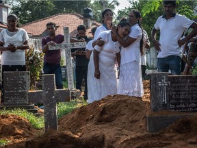 NEGOMBO, SRI LANKA - APRIL 23: A woman is overcome with grief during a funeral for one of the victims killed in the Easter Sunday attack on St Sebastian's Church, on April 23, 2019.