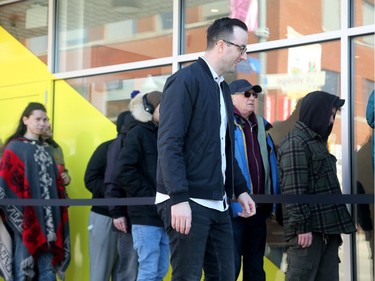 Harrison Stoker, VP of Brand and Culture with the Donnelly Group that owns the store, makes his way down the line, greeting people as they were allowed in shortly after 10 am. Hobo Recreational Cannabis Store on Bank Street was one of three pot retailers to open in Ottawa Monday (April 1, 2019) as part of the province's new cannabis retail model rollout.