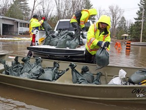 City of Ottawa employees bring sandbags to homes on Boisé Lane that are being flooded by the Ottawa River in Cumberland on Friday, April 26, 2019.
