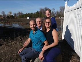 Joy (back right) and Nicholas (back left) Ralph are enjoying the fact that their daughter Holly Ralph and partner Michael Adam will be buying a house (in the empty field) behind their home (white picket fence),  April 25, 2019.