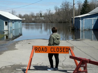 Lanark Village resident Kim Gunn surveys what used to be the road leading to the village beach, still under water. Water levels had receded by two to three feet in Lanark Village by Thursday (April 25, 2019).  However, some homes remained surrounded by water and residents were bracing for another downpour of rain and wondering how high the Clyde River could climb.  Julie Oliver/Postmedia