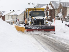 A snowplow clears Beatrice Drive following a winter storm in Ottawa on February 13, 2019.