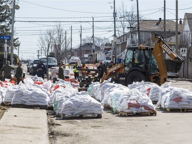 Members of the Canadian Forces Royal 22nd Regiment fill sand bags to protect against rising flood waters in Gatineau, Quebec on April 22, 2019.