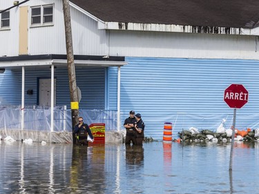 A Gatineau firefighters collect data in rising flood waters on Rue Saint Louis in Gatineau, Quebec on April 22, 2019.