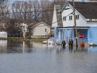 A Gatineau firefighters collect data in rising flood waters on Rue Saint Louis in Gatineau, Quebec on April 22, 2019.