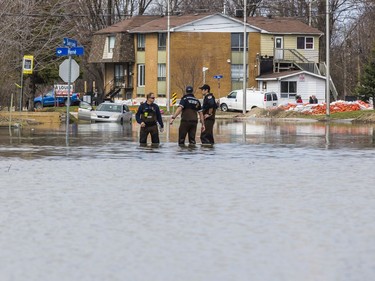 A Gatineau firefighters collect data in rising flood waters on Rue Saint Louis in Gatineau, Quebec on April 22, 2019.