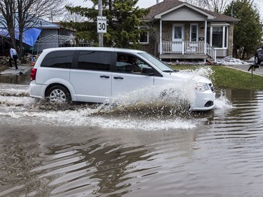 A van drives down a flooded rue Moreau in Gatineau, Quebec on April 23, 2019.