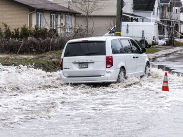 A van drives down a flooded rue Moreau in Gatineau, Quebec on April 23, 2019.