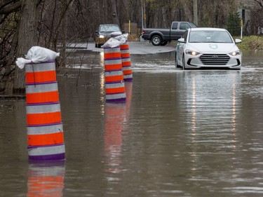 A car drives on a flooded Fraser Road in Gatineau on April 26, 2019.