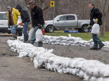 Residents build a wall of sandbags along Rue Lamoureux in Gatineau on April 26, 2019.