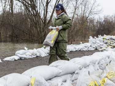 Miranda Stewart builds a wall of sandbags along Rue Lamoureux in Gatineau on April 26, 2019.