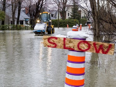 Heavy equipment delivers sandbags to combat flooding on Fraser Road in Gatineau on April 26, 2019.