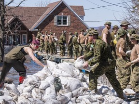 Members of the Canadian Armed Forces move sandbags to  combat flood waters in Cumberland on April 28, 2019. Errol McGihon/Postmedia