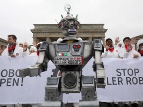 People take part in a demonstration as part of the campaign "Stop Killer Robots" organised by German NGO "Facing Finance" to ban what they call killer robots on March 21, 2019 in front of the Brandenburg Gate in Berlin. The campaign to "Stop Killer Robots" is a global coalition of 82 international, regional, and NGOs in 35 countries that asks for a ban on lethal fully autonomous weapons.
