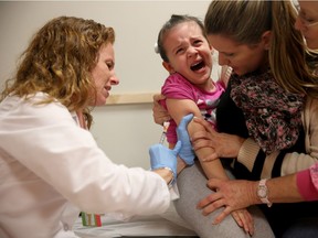 In this file photo, Miami Dr. Amanda Porro administers a measles vaccination to Sophie Barquin, 4.