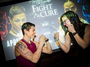 Fighters Megan Apostoleris, a police officer with the RCMP, and Afton Maisonneuve, an associate with Kelly Santina, face off Thursday night.
