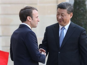 French President Emmanuel Macron (L) shakes hands with Chinese President Xi Jinping after a meeting at the Elysee Palace in Paris, on March 26, 2019, at the end of a state visit by the powerful Chinese leader.