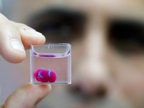 Scientists in Israel on Monday unveiled a 3D print of a heart with human tissue and vessels, calling it a first and a "major medical breakthrough" that advances possibilities for transplants.