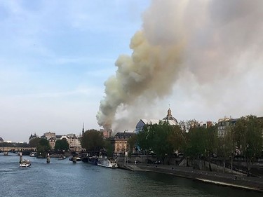 Flames and smoke are seen billowing from the roof at Notre-Dame Cathedral in Paris on April 15, 2019. - A fire broke out at the landmark Notre-Dame Cathedral in central Paris, potentially involving renovation works being carried out at the site, the fire service said.Images posted on social media showed flames and huge clouds of smoke billowing above the roof of the gothic cathedral, the most visited historic monument in Europe.