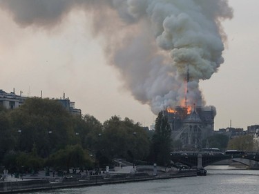 Smokes ascends as flames rise during a fire at the landmark Notre-Dame Cathedral in central Paris on April 15, 2019 afternoon, potentially involving renovation works being carried out at the site, the fire service said.