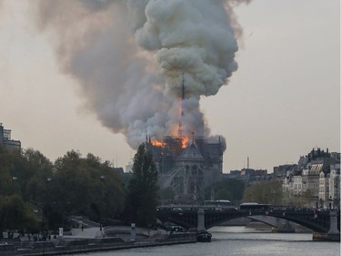 Smokes ascends as flames rise during a fire at the landmark Notre-Dame Cathedral in central Paris on April 15, 2019 afternoon, potentially involving renovation works being carried out at the site, the fire service said.