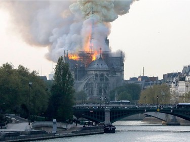 Smokes ascends as flames rise during a fire at the landmark Notre-Dame Cathedral in central Paris on April 15, 2019 afternoon, potentially involving renovation works being carried out at the site, the fire service said.