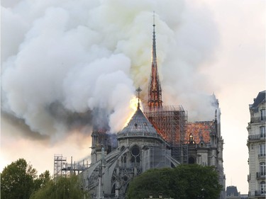 Plumes of smoke and flames rise during a fire at the landmark Notre-Dame Cathedral in central Paris on April 15, 2019, potentially involving renovation works being carried out at the site, the fire service said. - A major fire broke out at the landmark Notre-Dame Cathedral in central Paris sending flames and huge clouds of grey smoke billowing into the sky, the fire service said. The flames and smoke plumed from the spire and roof of the gothic cathedral, visited by millions of people a year, where renovations are currently underway.