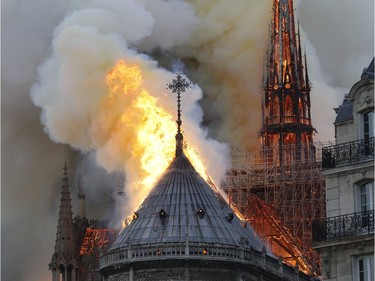 Flames burn the roof of the landmark Notre-Dame Cathedral in central Paris on April 15, 2019, potentially involving renovation works being carried out at the site, the fire service said. - A major fire broke out at the landmark Notre-Dame Cathedral in central Paris sending flames and huge clouds of grey smoke billowing into the sky, the fire service said. The flames and smoke plumed from the spire and roof of the gothic cathedral, visited by millions of people a year, where renovations are currently underway.
