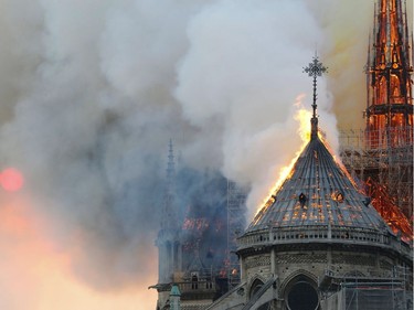 Flames burn the roof of the landmark Notre-Dame Cathedral in central Paris on April 15, 2019, during a fire. - A major fire broke out at the landmark Notre-Dame Cathedral in central Paris sending flames and huge clouds of grey smoke billowing into the sky, the fire service said. The flames and smoke plumed from the spire and roof of the gothic cathedral, visited by millions of people a year, where renovations are currently underway.