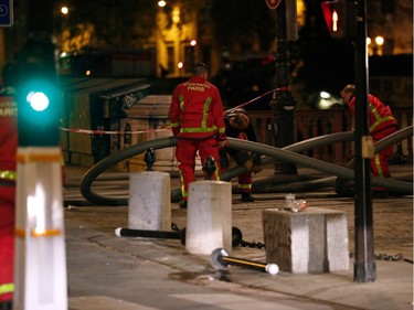 Firefighters are seen working near Notre-Dame Cathedral in Paris early on April 16, 2019.