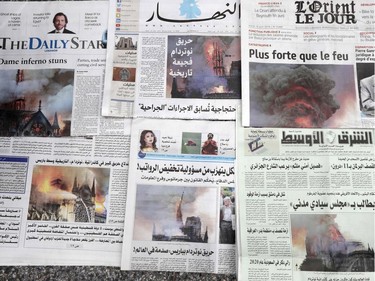 Lebanese newspapers, featuring images of the fire that ravaged the Parisian Notre Dame cathedral on their front pages, are spread out at a newspaper satll in the capital Beirut,  on April 16, 2019. - Paris was struck in its very heart as flames devoured the roof of Notre-Dame, the medieval cathedral made famous by Victor Hugo, its two massive towers flanked with gargoyles instantly recognisable even by people who have never visited the city.