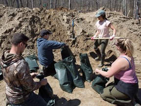 Volunteers fill sandbags in Constance Bay, west of Ottawa, on April 28.