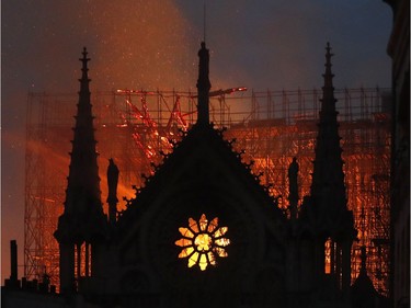 Flames and smoke rise from Notre Dame cathedral as it burns in Paris on Monday.