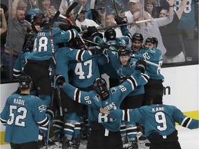 San Jose Sharks players celebrate after defeating the Vegas Golden Knights in Game 7 of an NHL hockey first-round playoff series in San Jose, Calif., Tuesday, April 23, 2019. The Sharks won 5-4 in overtime.