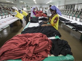 Files:  Workers embroider t-shirts with logos on the production line of the Viyellatex Group garment factory in Gazipur, Bangladesh