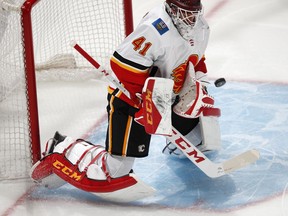 Calgary Flames goaltender Mike Smith stops a shot by the Colorado Avalanche during the first period of Game 4 of an NHL hockey playoff series Wednesday, April 17, 2019, in Denver.